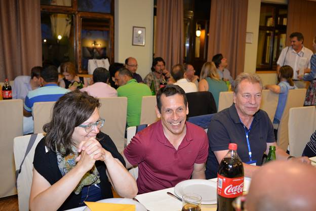 A group of people sitting at a table in a restaurant

Description generated with very high confidence