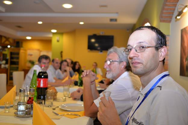 A group of people sitting at a table

Description generated with very high confidence