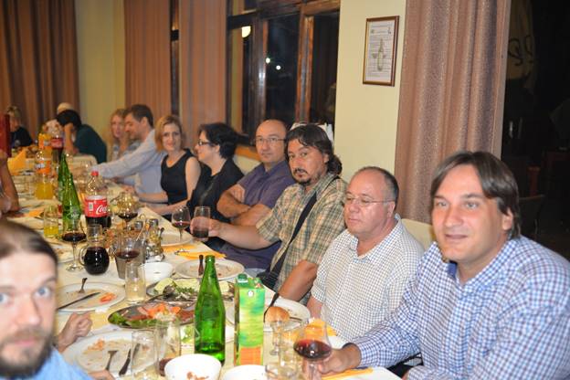 A group of people sitting at a dinner table

Description generated with very high confidence