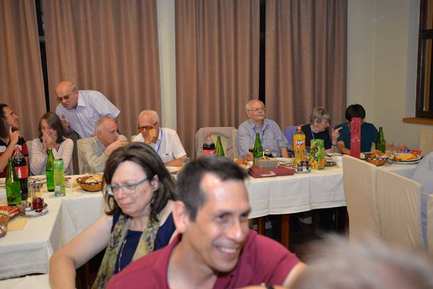 A group of people sitting at a table

Description generated with very high confidence