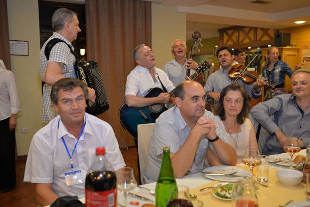 A group of people sitting at a table with wine glasses

Description generated with very high confidence