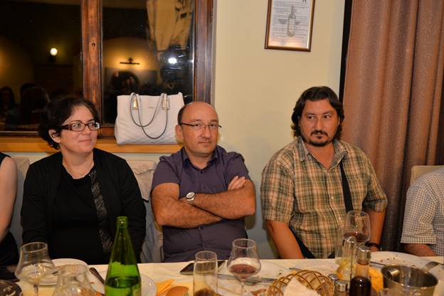 A group of people sitting at a table with wine glasses

Description generated with very high confidence