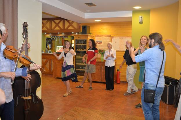 A group of people standing in a room

Description generated with very high confidence