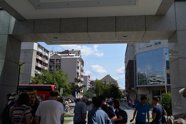 A group of people standing in front of a building

Description generated with very high confidence