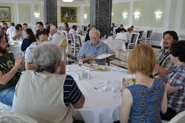 A group of people sitting at a table

Description generated with very high confidence