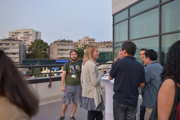 A group of people standing in front of a building

Description generated with very high confidence